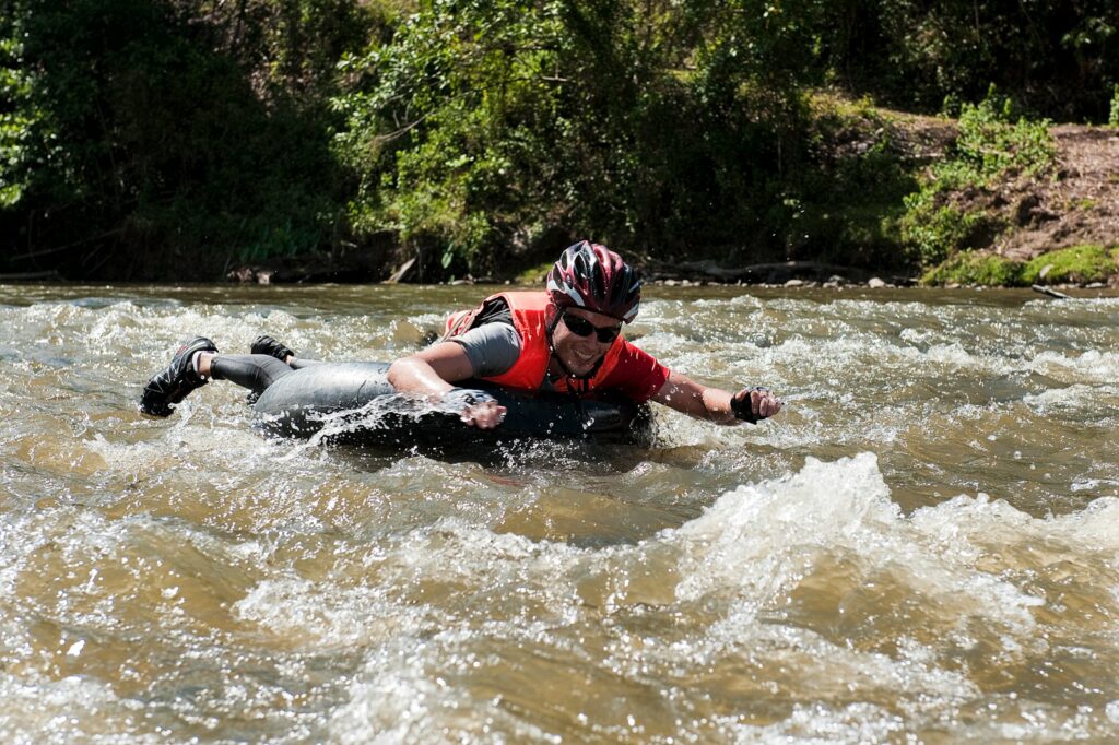 A man riding a raft down a river